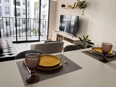 a table with two plates and two glasses on it at Calm and beautiful apartment in San Isidro in Lima