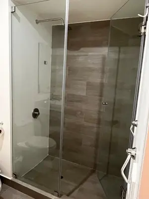 a shower with a glass door in a bathroom at Calm and beautiful apartment in San Isidro in Lima