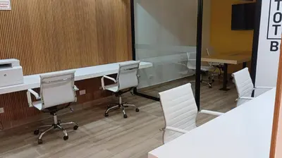 an office with chairs and a desk and a table at Calm and beautiful apartment in San Isidro in Lima