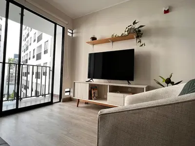 a living room with a flat screen tv on a wall at Calm and beautiful apartment in San Isidro in Lima