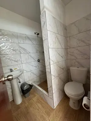 a bathroom with a shower and a toilet and a sink at San Bartolo house rental in San Bartolo