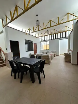 a large living room with a table and chairs at San Bartolo house rental in San Bartolo