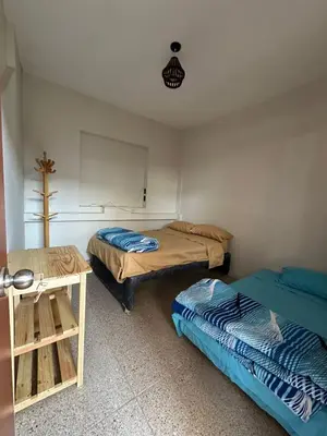 a room with two beds and a table in it at San Bartolo house rental in San Bartolo