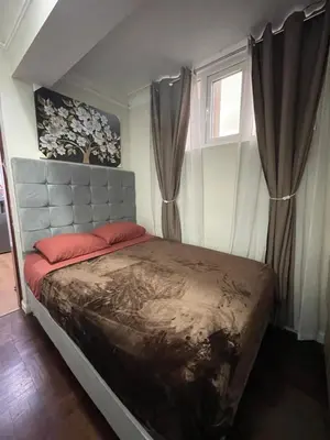 a bedroom with a large bed with red pillows at Mini Apartment ARES in Lima