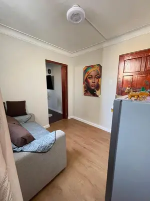 a room with a bed and a refrigerator in it at Mini Apartment ARES in Lima