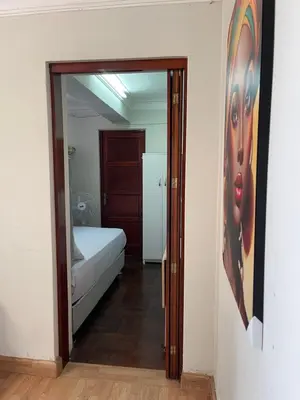 a bedroom with a bed and a painting on the wall at Mini Apartment ARES in Lima