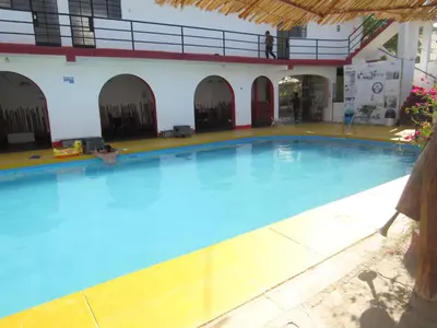 a large swimming pool in a building at Hospedaje snack bar titanic in Ica