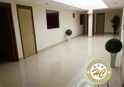 a hallway with two plants in a building at Pisco Hospedaje Corina in Pisco