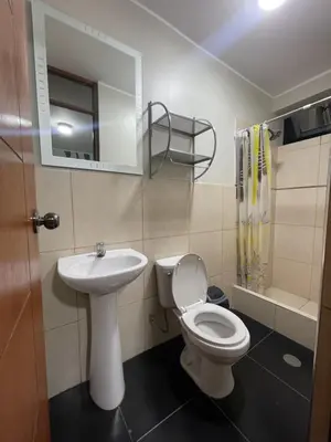 a bathroom with a toilet and a sink at Agora Hs in Chincha