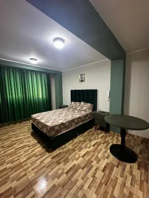 a bedroom with a bed and a table in it at Agora Hs in Chincha