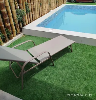 a bench sitting next to a swimming pool at CASA DE PLAYA FRENTE AL MAR k173 in San Vicente de Cañete