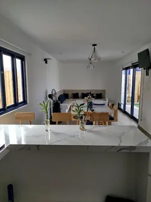 a living room with a table and a couch at CASA DE PLAYA FRENTE AL MAR k173 in San Vicente de Cañete