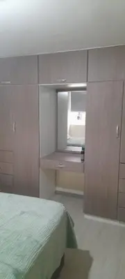 a bedroom with a bed and a mirror at DEPARTAMENTO Central in Lima