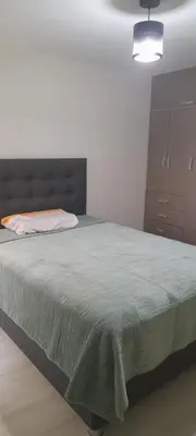 a bedroom with a bed and a dresser at DEPARTAMENTO Central in Lima