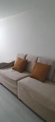 a couch with two pillows on it in a room at DEPARTAMENTO Central in Lima