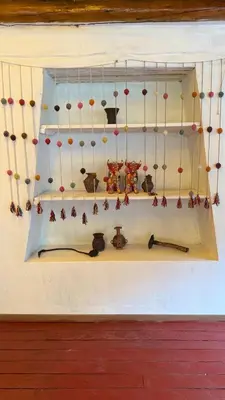 a shelf with many different items on a wall at Andenes del Inca Hotel in Ollantaytambo