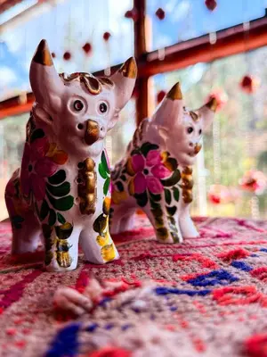 two figurines of cats sitting on a table at Andenes del Inca Hotel in Ollantaytambo
