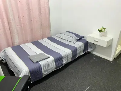 a bedroom with a bed with a blue and white striped blanket at Habitación con baño particular, lindas áreas comunes in Lima