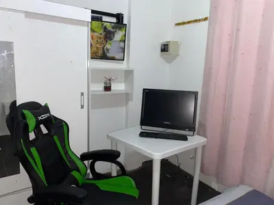 a laptop computer sitting on a white table with a chair at Habitación con baño particular, lindas áreas comunes in Lima
