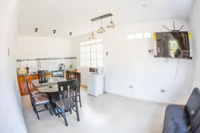 a kitchen and dining room with a table and chairs at Edelweiss Haus in Chontabamba