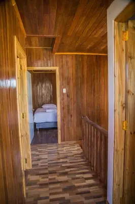 a wooden hallway with a bed in a room at Edelweiss Haus in Chontabamba