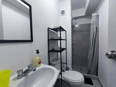a bathroom with a sink and a toilet and a shower at Departamento Playa Arica - Lurín in Lurín
