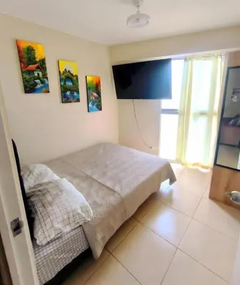 a bedroom with a bed and paintings on the wall at Departamento Playa Arica - Lurín in Lurín