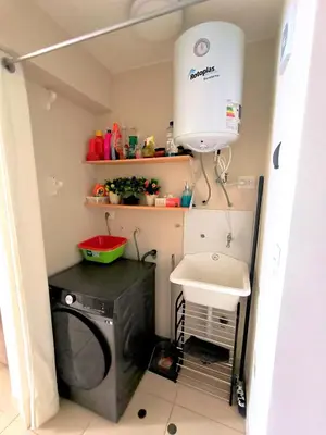 a laundry room with a washing machine and a sink at Departamento Playa Arica - Lurín in Lurín