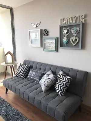 a gray couch with pillows in a living room at Moderno Dpto , Equipado, Céntrico, Vista Increible in Lima