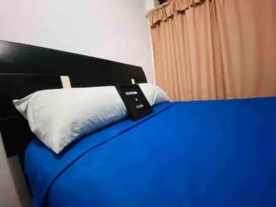 a bedroom with a blue bed with a white pillow at Minidepartamento La Molina Junin 1 in Lima