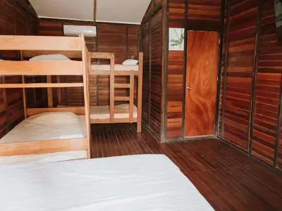 a room with two bunk beds and a door at HOSPEDAJE CasaBlanca Huacachina in Ica