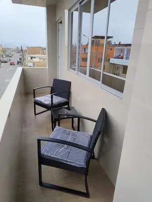 two chairs and a bench on a balcony at Hotel MAXIMUM COMFORT FCA in Salinas