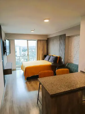 a hotel room with a bed and a large window at LA POSADA DE GUILLE - JAVIER PRADO Este 1501 in Lima