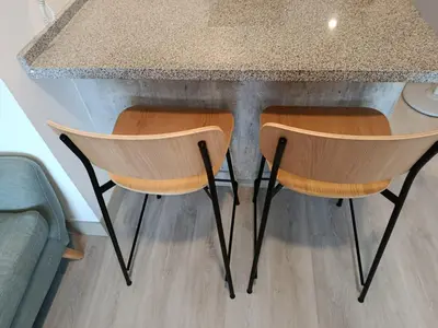 two chairs sitting at a counter in a kitchen at LA POSADA DE GUILLE - JAVIER PRADO Este 1501 in Lima