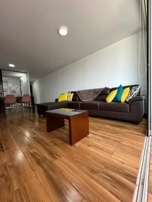 a living room with a couch and a table at El Derby 511 Apart 2 Dorm con Aire Acondicionado in Lima
