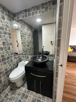 a bathroom with a black sink and a toilet at El Derby 511 Apart 2 Dorm con Aire Acondicionado in Lima