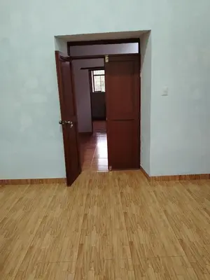 an empty room with a door and a wooden floor at Hotel House in Perú 2 in Urubamba