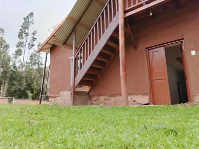 a house with a staircase on the side of it at Hotel House in Perú 2 in Urubamba