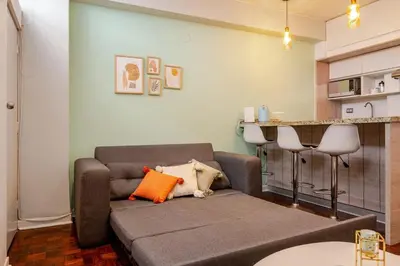 a living room with a couch and a kitchen at Mini depa en el corazón de Miraflores in Lima