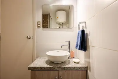 a bathroom with a white bowl sink on a counter at Mini depa en el corazón de Miraflores in Lima