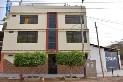 a building with a fire hydrant in front of it at hostal kiara in Huairona