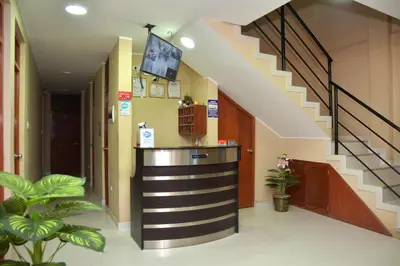 a lobby with a staircase and a bar in a building at hostal kiara in Huairona