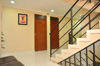 a living room with stairs and a door at hostal kiara in Huairona