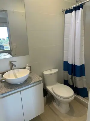 a white bathroom with a toilet and a sink at Casa Paraquitas 
