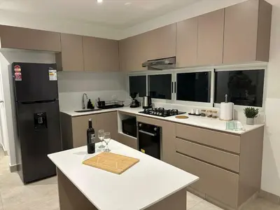 a kitchen with a white counter and a refrigerator at Casa Paraquitas 