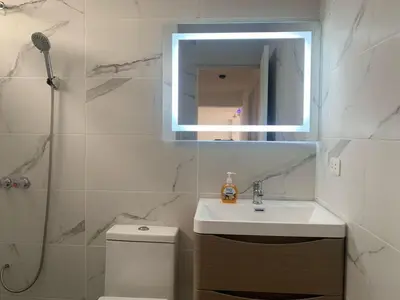 a bathroom with a sink and a mirror and a toilet at Departamento en Miraflores in Lima