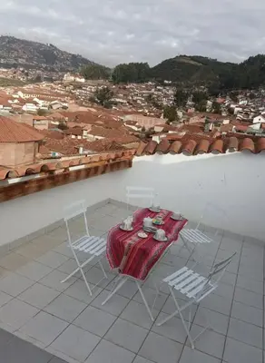 a table and chairs on top of a roof at Añay Ayllu in Cusco