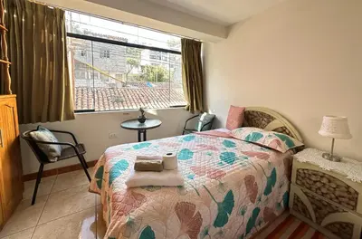 a bedroom with a bed and a window at Adela's Home in Cusco