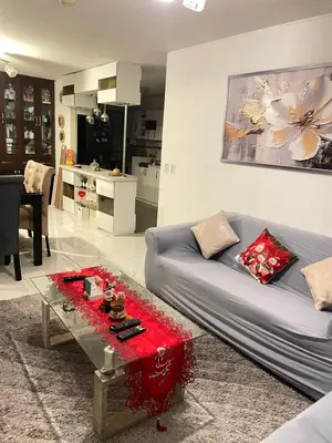 a living room with a couch and a table at El encanto de viajar in Lima