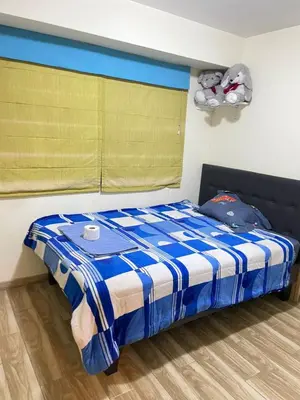 a bedroom with a bed with a blue and white blanket at El encanto de viajar in Lima